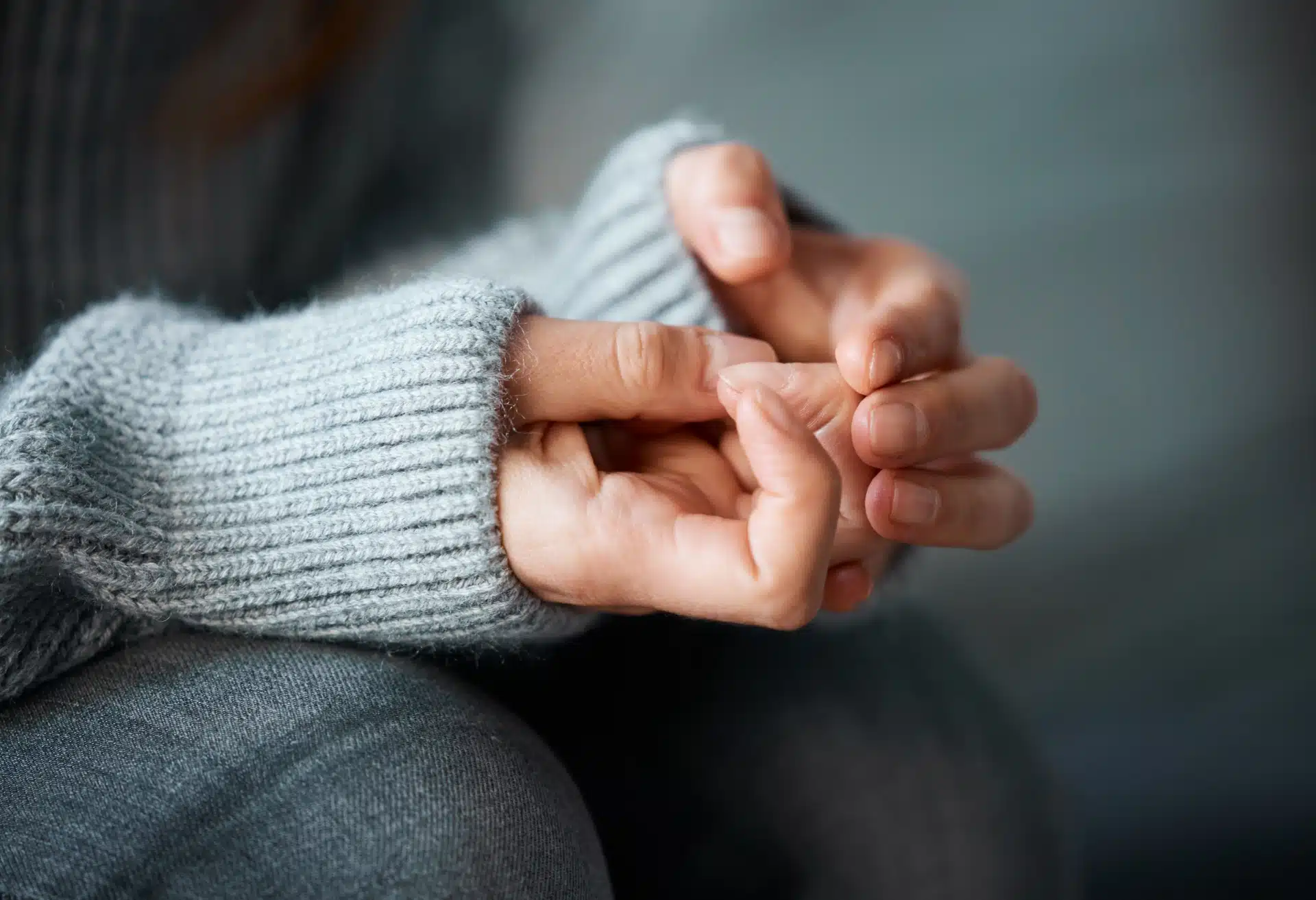 En kvinne piller på huden rundt neglene sine, hun har angst
